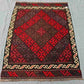Floor scene with Afghan small Kilim flatweave – geometric design in red wool.