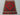 Floor scene with Afghan small Kilim flatweave – geometric design in red wool.
