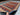 Handmade wool rug with tribal camel motifs – in-hand view