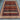Handmade tribal animal wool rug placed on wooden floor