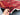 In-hands view of 9x13.2 antique handmade Persian red rug