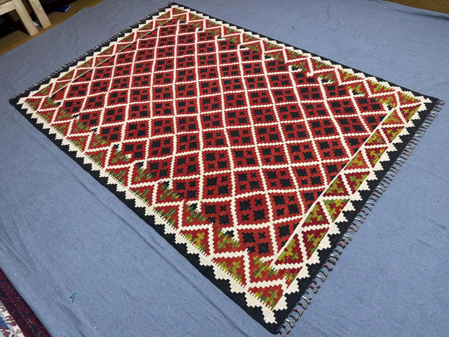 Vintage red kilim wool rug in boho living room – handmade area carpet