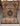 Complete overhead view of handmade artisan silk rug with detailed floral pattern.