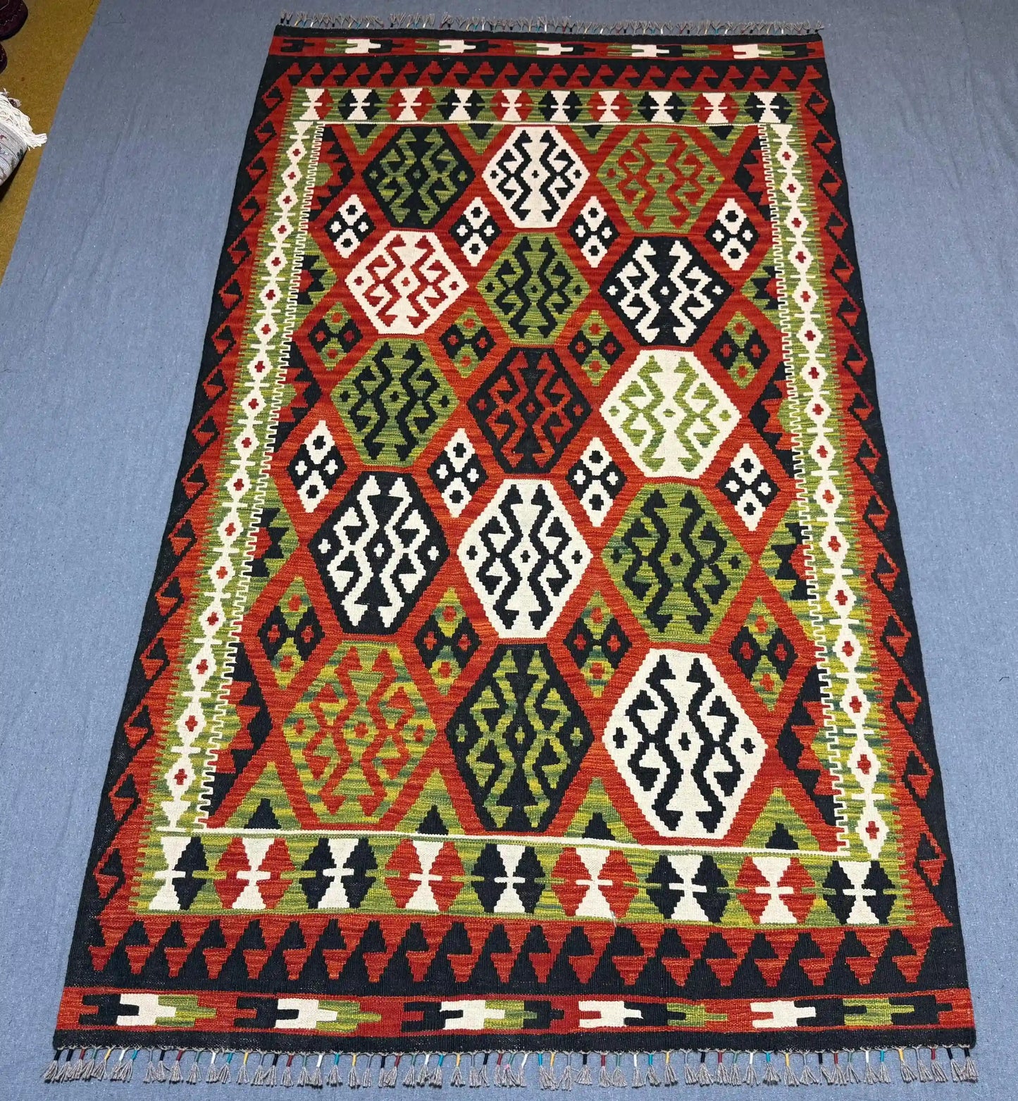  Authentic Turkish flatweave rug shown on hardwood floor.