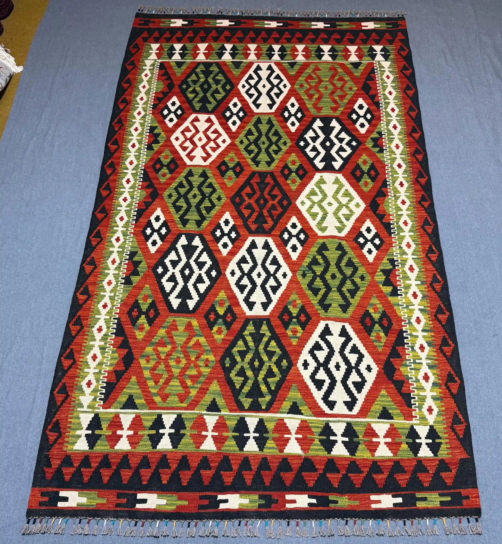  Authentic Turkish flatweave rug shown on hardwood floor.