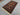 Side view of handmade tribal Baluch carpet on floor