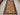 Handmade Baluchi wool rug placed in rustic room with wooden flooring