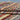 Side view of folded Barjasta wool rug – handmade and knotted