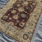 Wool Oushak rug on floor in rustic style room – tribal oriental patterns