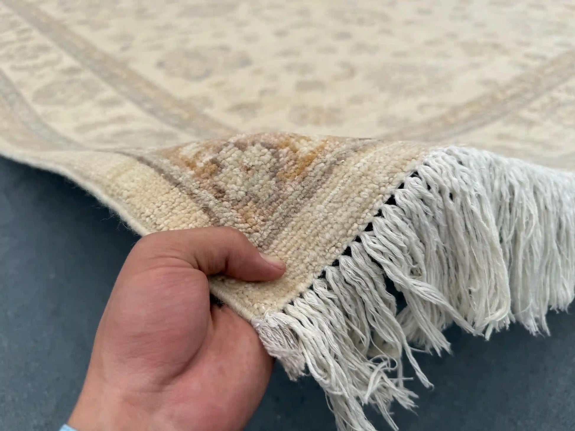 In-hand view of 8x9.11 ft handmade beige & taupe Ziegler wool rug