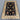 Black and beige Turkish rug placed on hardwood floor in traditional setting