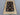 Black and beige Turkish rug placed on hardwood floor in traditional setting