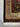 Fringed corner of black and gold 4x5 silk Persian rug – handmade luxury