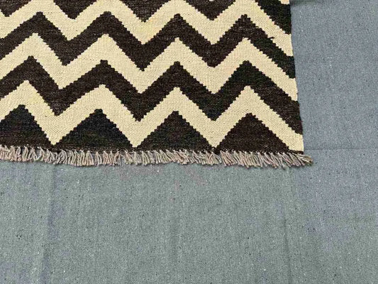 Corner edge of Kilim rug showing precise hand-knotted finish