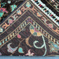 Folded view of Black Sultani runner rug showing wool thickness