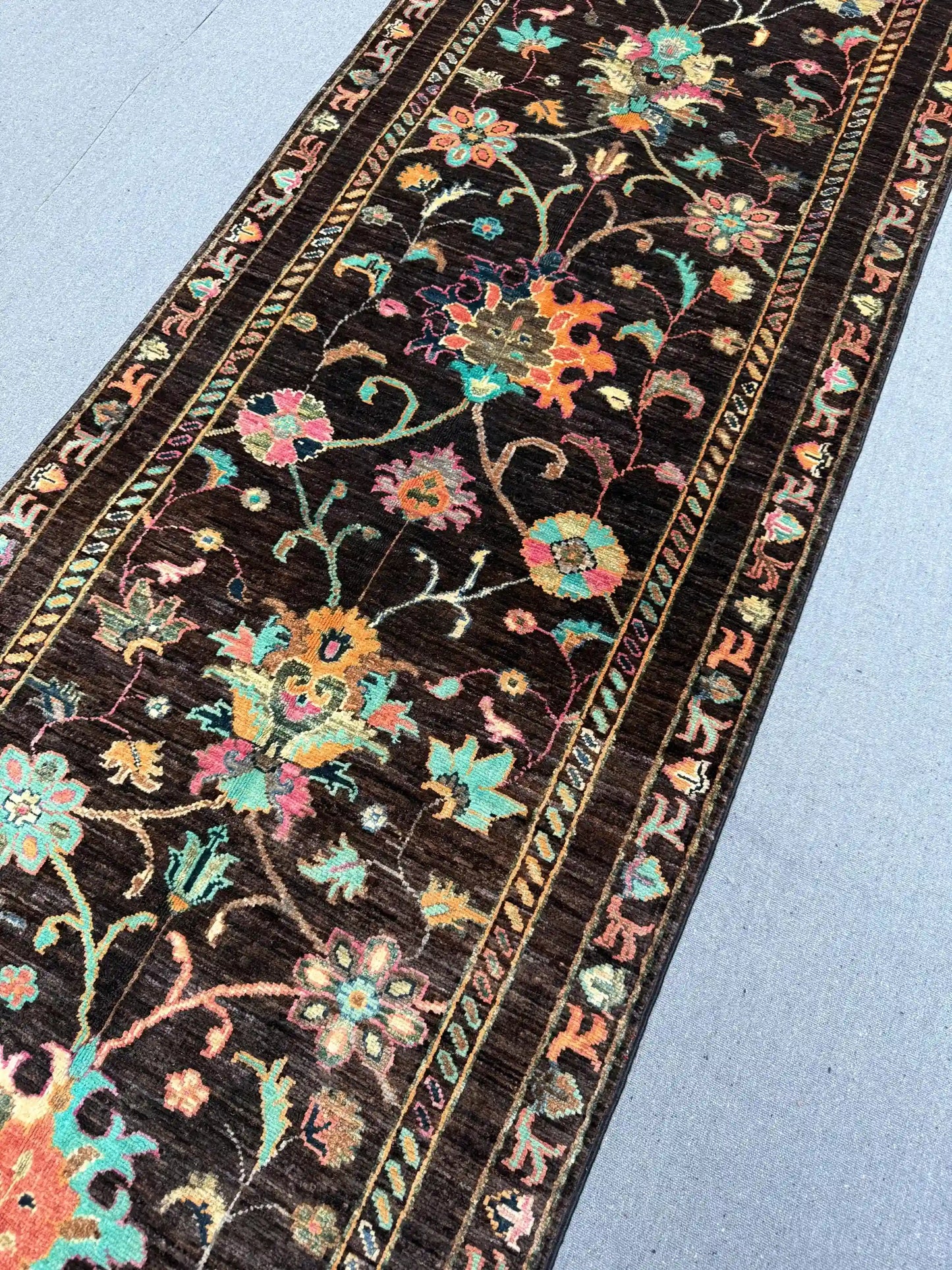 Detailed stitching of knotted handmade Persian-style runner rug