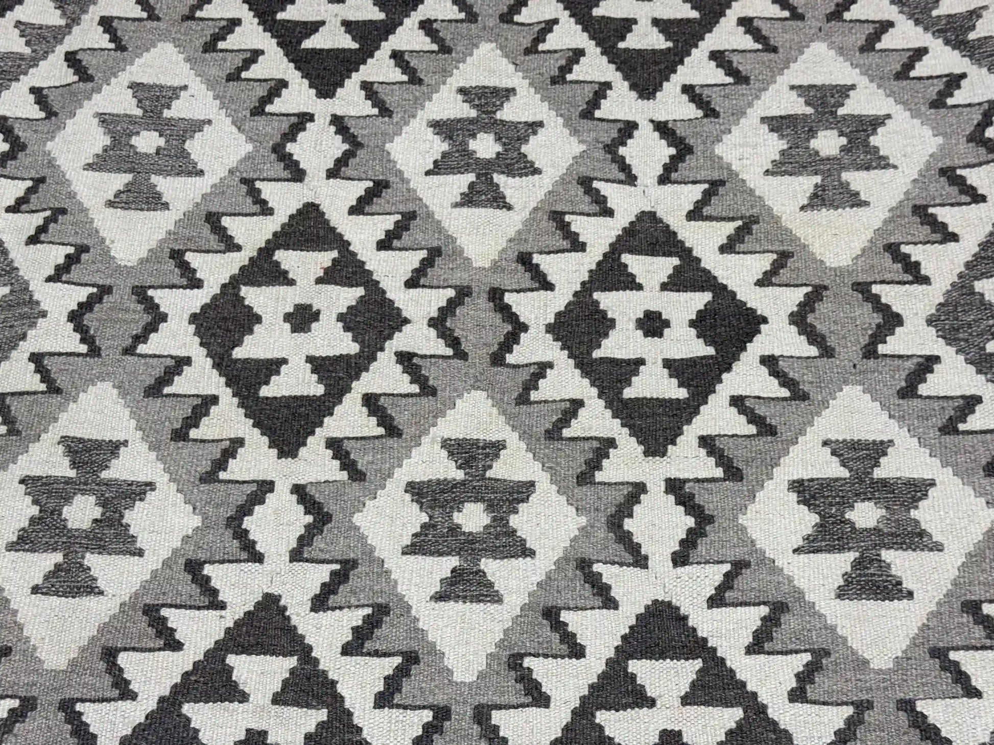 Close-up of wool flatweave texture on handmade Turkish Kilim rug.