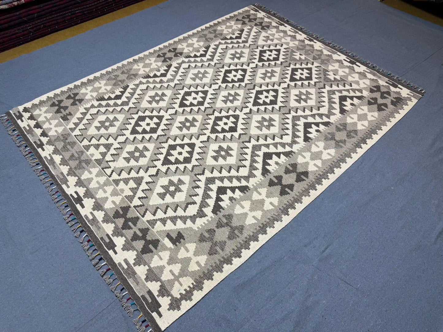 Black and white Kilim rug displayed on modern living room floor