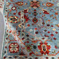 Backside folding detail of hand-knotted floral rug