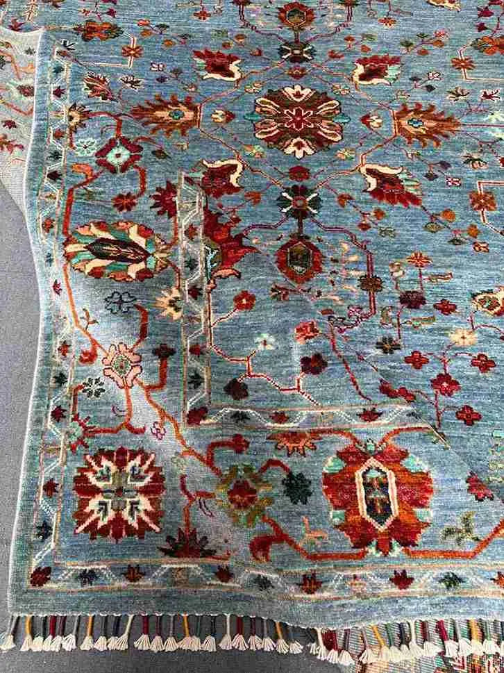 Backside folding detail of hand-knotted floral rug