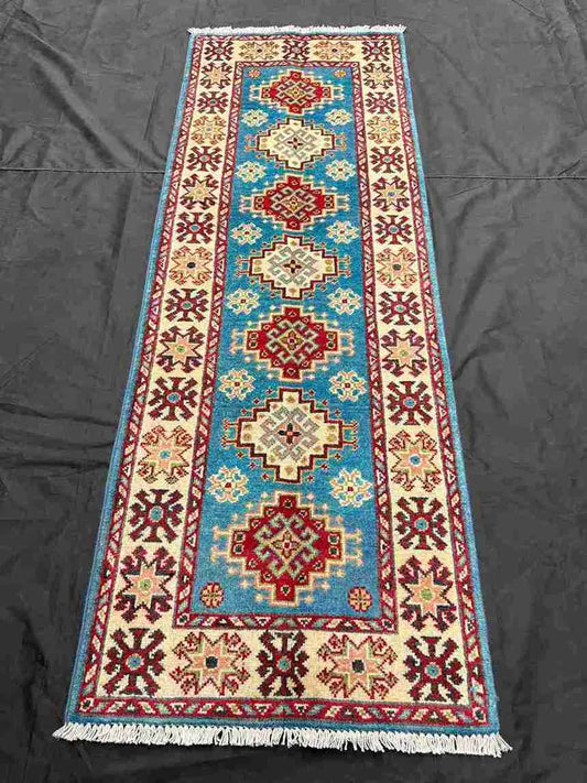 Top view of red and blue handmade runner rug in hallway