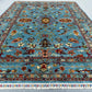 5x7 light blue and red oriental rug styled in interior