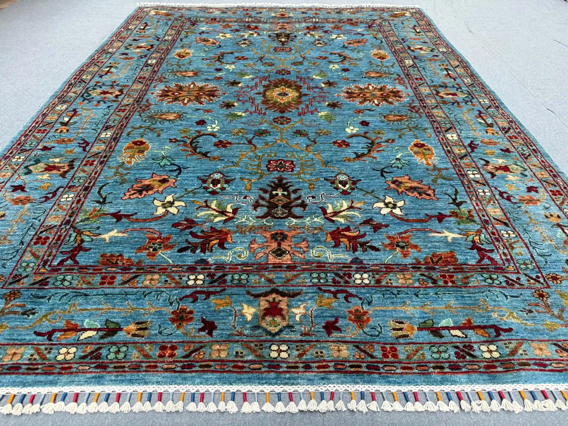 5x7 light blue and red oriental rug styled in interior