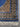 Corner detail of knotted blue silk rug – Persian medallion design