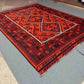 Boho interior floor decor featuring vintage red and black Turkish Kilim rug – wool flatweave.