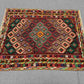 Afghan kilim rug styled on floor with boho-inspired home decor