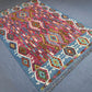 Boho-style Turkish rug with tribal patterns displayed on modern flooring.