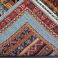 Folded view of vintage kilim carpet with nomadic boho-style patterns