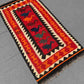Boho interior with red and orange Turkish Kilim rug – handmade wool flatweave on floor