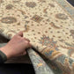 Authentic 6x8 handmade Chobi carpet shown in hands, beige and green wool