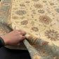 Authentic 6x8 Chobi carpet in hands showing hand-knotted wool texture