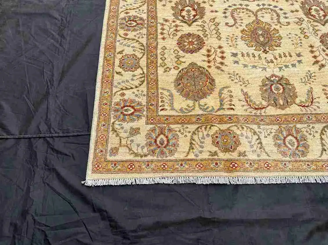 Corner floral detail on authentic 5x7 ivory Chobi rug – Persian-style design.