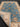Blue and beige Chobi wool carpet partially folded