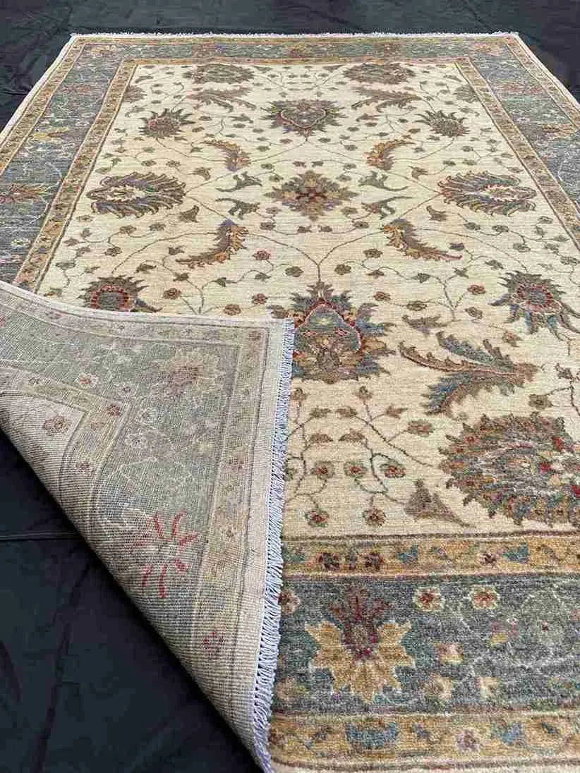 Pattern detail of folded 6x8 beige and green Chobi carpet