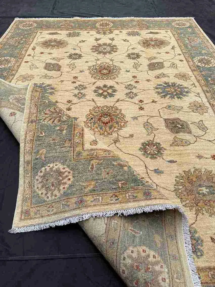 Side view of handmade Chobi rug in folded form