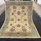 Full view of authentic handmade Chobi rug with floral design in beige and green