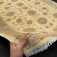 Authentic 6x8 Chobi rug in hands showing hand-knotted wool texture