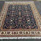 Navy blue Chobi rug placed in living room with floral decor