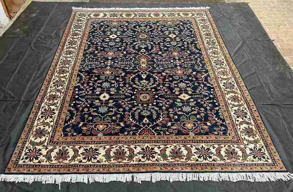 Navy blue Chobi rug placed in living room with floral decor