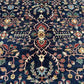 Detailed close-up of floral design on navy blue handmade Chobi rug
