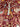 Close-up of bird and tree detail on handmade red wool Persian rug