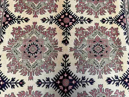 Detailed pattern of handmade Persian-style Afghan rug in red and beige