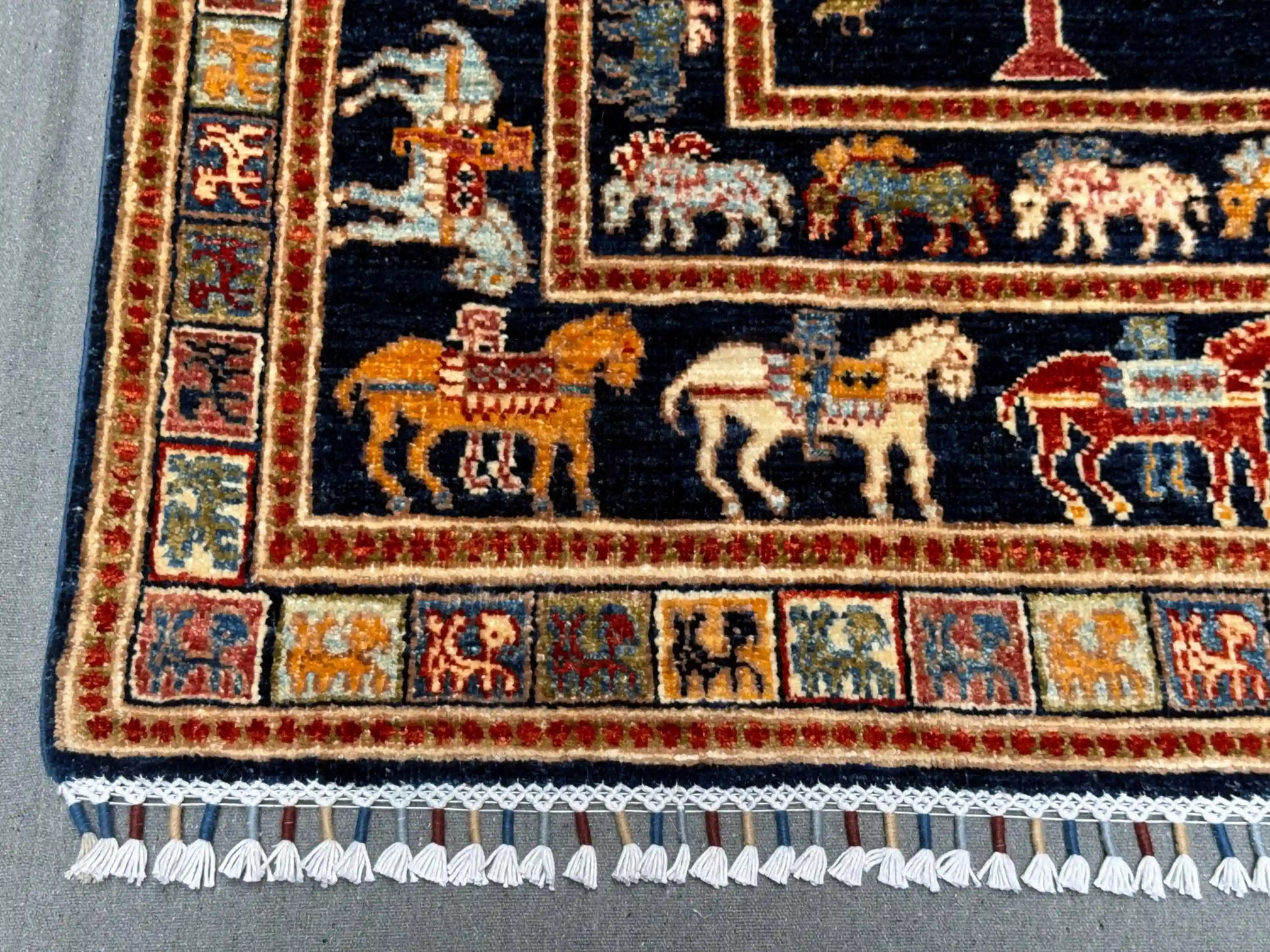 Close-up of horse motif on dark blue Tree of Life wool rug