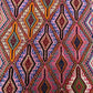 Close-up of colorful tribal pattern on Turkish kilim hallway rug