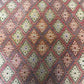 Close-up of beige and gold tribal pattern on vintage Afghan Turkish wool rug