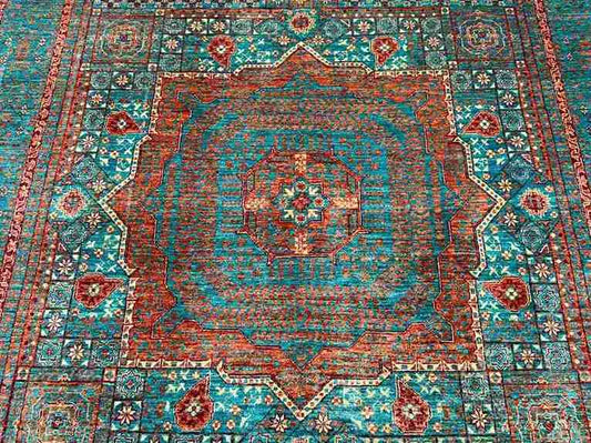 Close-up of geometric Mamluk rug pattern in turquoise, red, and green